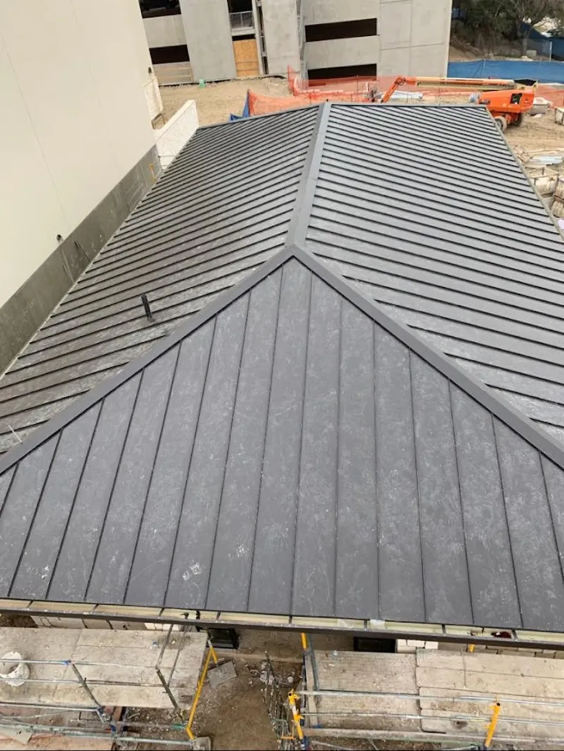 Commercial metal roof construction with crane equipment in Ocean