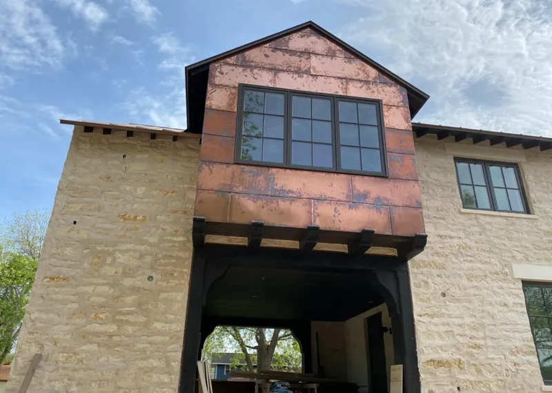 Copper metal panel facade on a stone building for Skylight Installation in Ocean