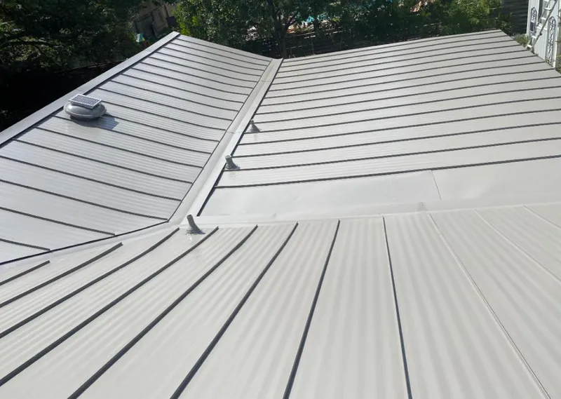 Solar attic fan installed on a metal roof for Roof Ventilation in Ocean